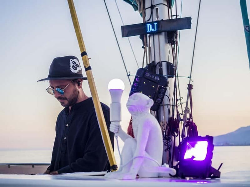 Malaga: Sailing Catamaran Sunset Cruise with Live DJ & Drink - Leaving Málaga Port as the sun drops